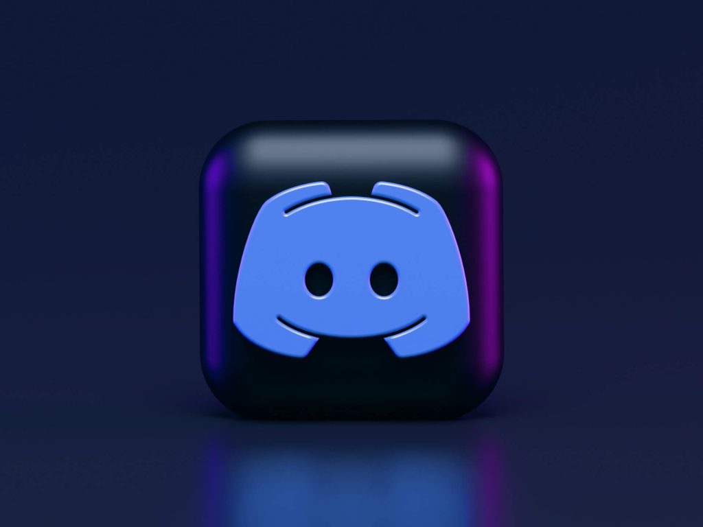 3D version of Discord icon floating in the center of the image across a dark background